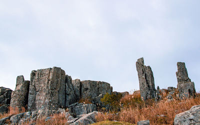 Rock formations on mountain against sky