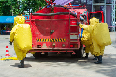 Firefighters standing by fire engine