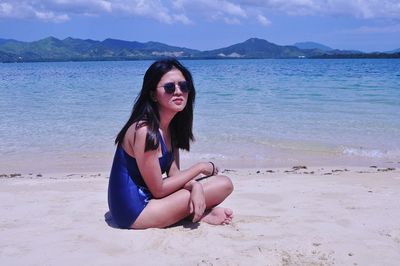 Full length of young woman at beach