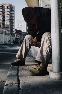 Close-up of man with umbrella on street