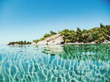 Scenic view of sea against clear blue sky