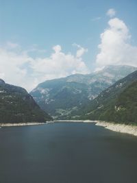 Scenic view of mountains against cloudy sky