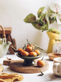 Orange santang fruits on green vintage mini tier. brightmood stilllife photography