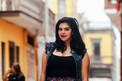 Portrait of beautiful young woman standing outdoors