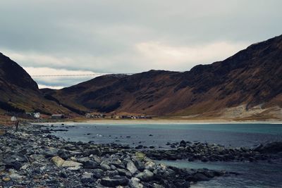 Scenic view of sea and mountains against sky