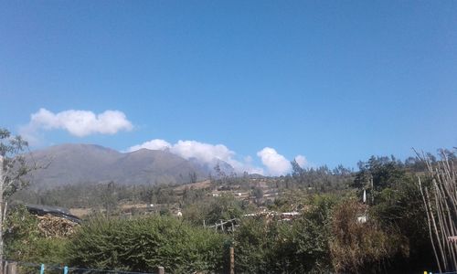 Panoramic view of landscape against blue sky