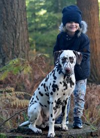 Portrait of man with dog in forest