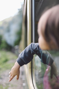 Girl looking through train window