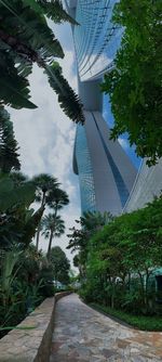 Low angle view of bridge amidst buildings against sky