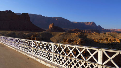 Bridge over mountains against clear blue sky