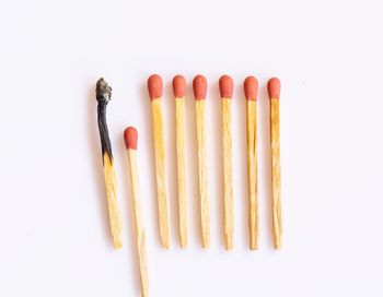 High angle view of multi colored pencils against white background