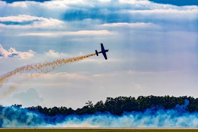 Low angle view of airplane flying against sky