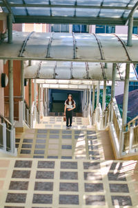 Full length of woman walking by building