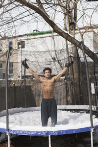 Young male boxer posing in the snow