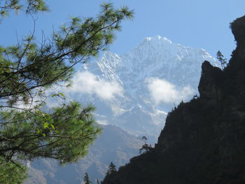 Low angle view of snowcapped mountains against sky