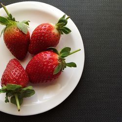 High angle view of strawberries in plate on table