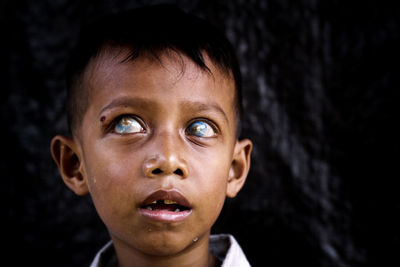 Close-up of poor boy looking away