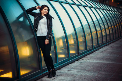 Young woman standing on street in city