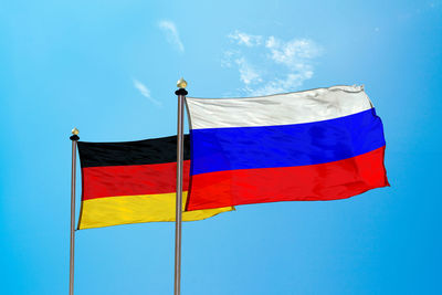 Flags against blue sky