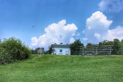 Houses on field against sky