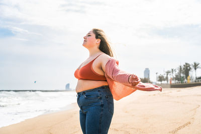 Young woman standing at beach