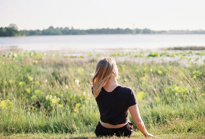 Rear view of woman standing on field