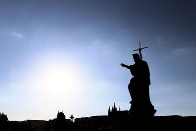 Low angle view of silhouette jesus christ statue against sky