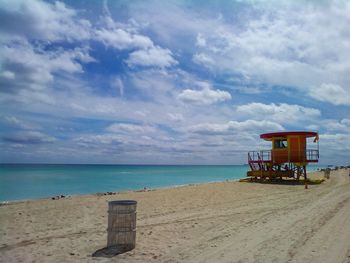 Lifeguard hut on beach against sky