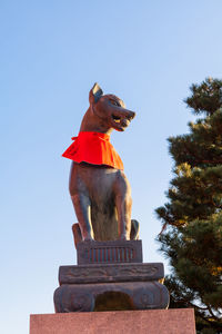 Low angle view of statue against clear blue sky