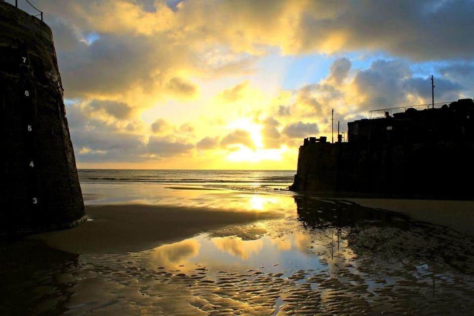 water, cloud - sky, sunset, reflection, sea, architecture, built structure, sky, building exterior, beach, outdoors, no people, travel destinations, nature, scenics, beauty in nature, horizon over water, city, day