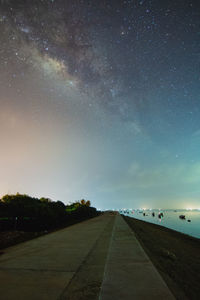 Road against sky at night