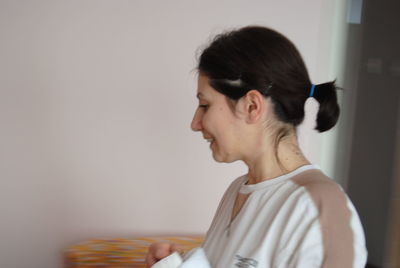 Portrait of young woman looking away at home