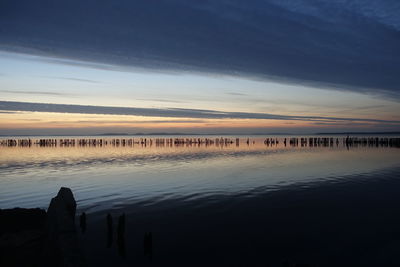 Scenic view of lake against sky during sunset