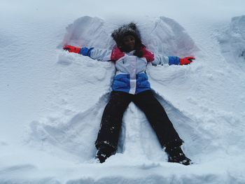 Full length of girl on snow covered field