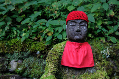 Statue of buddha against plants