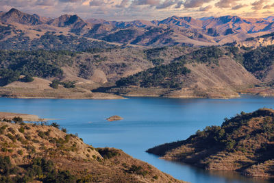 Scenic view of lake and mountains against sky