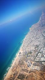 High angle view of sea and buildings in city