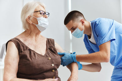 Midsection of man and woman standing in front of two people