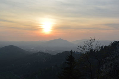 Scenic view of mountains against sky at sunset