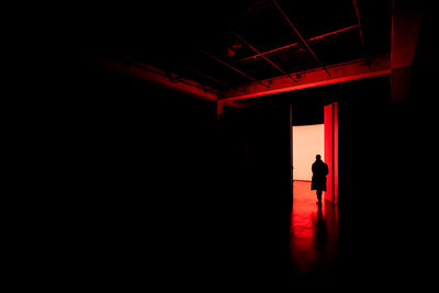 Silhouette man standing by building