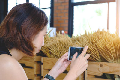 Close-up of young woman using smart phone