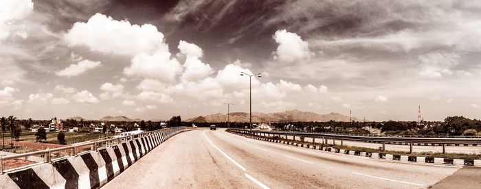 View of road against cloudy sky