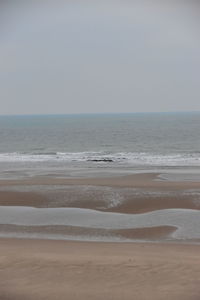 Scenic view of beach against clear sky