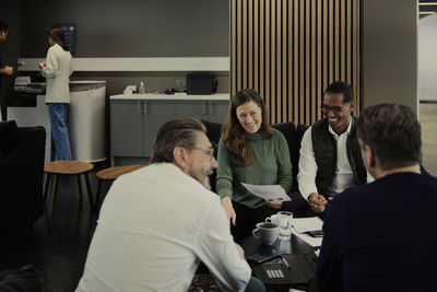 Group of business people having meeting in lobby