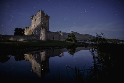 Reflections of ross castle at night in killarney national park, ireland.