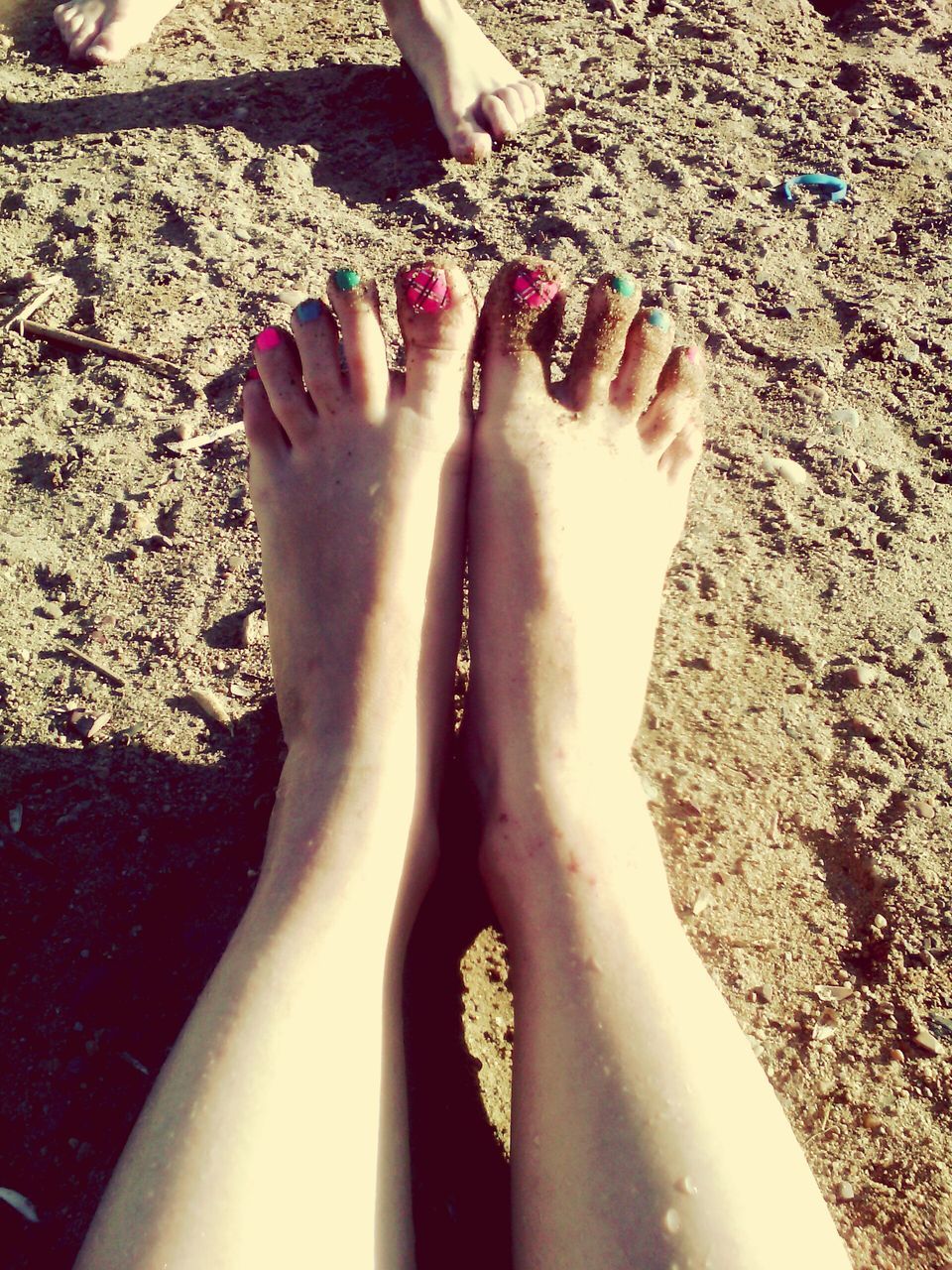 low section, person, barefoot, beach, human foot, sand, personal perspective, nail polish, relaxation, vacations, outdoors, sunbeam, day, nature, escapism, feet