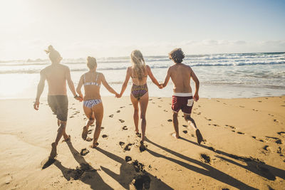 Rear view of people on beach