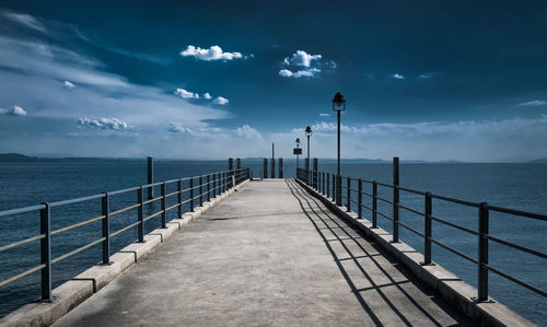 Pier over sea against sky