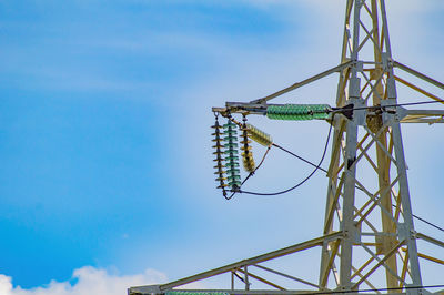 Low angle view of electricity pylon against sky