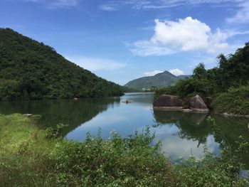 Scenic view of lake and trees against sky